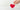 Hand holding a red heart above a slot in a white box.