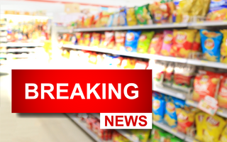 View of the chip aisle of a grocery store with a breaking news icon overlayed over top it.