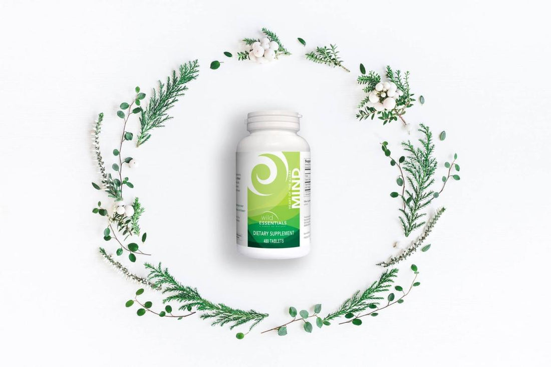 A bottle of New Earth's Mind supplements encircled by a green, flowery wreath.