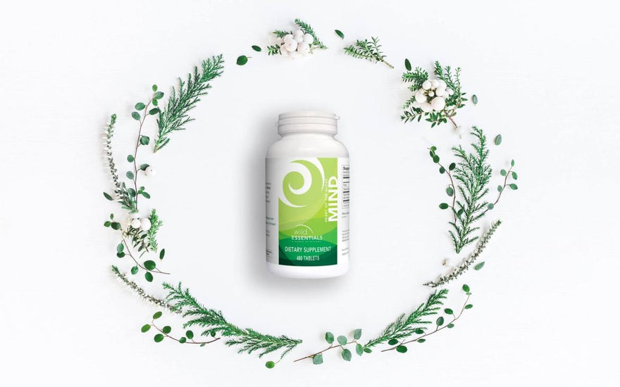 A bottle of New Earth's Mind supplements encircled by a green, flowery wreath.