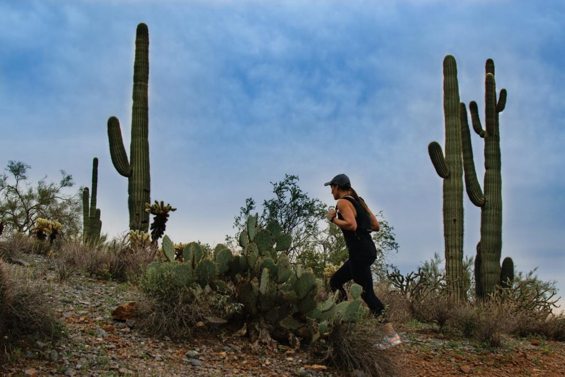 Woman hiking through a desert landscape.