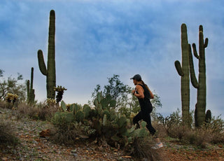 Woman hiking through a desert landscape.