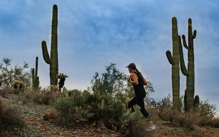 Woman hiking through a desert landscape.