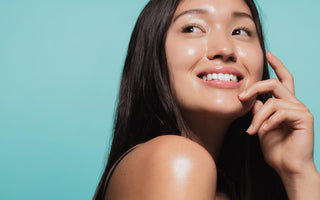 Close up of woman smiling and looking over her shoulder.