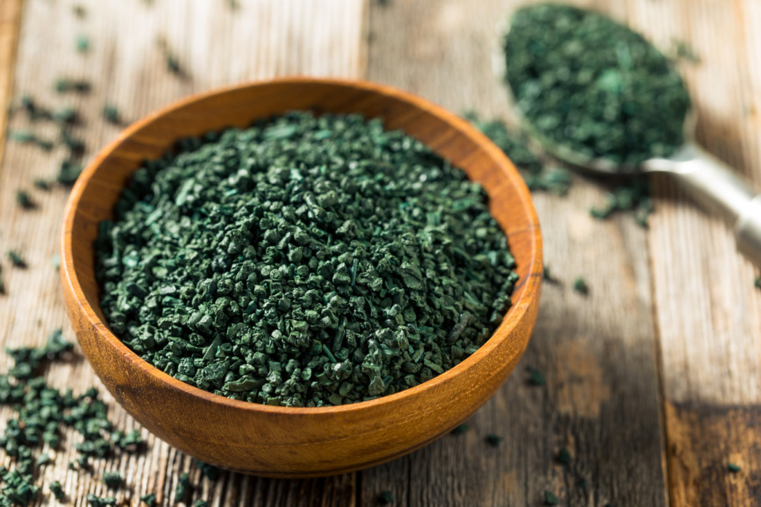 Wooden bowl of green, raw algae.