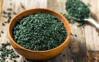 Wooden bowl of green, raw algae.