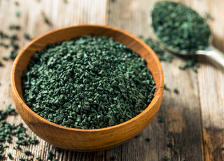 Wooden bowl of green, raw algae.