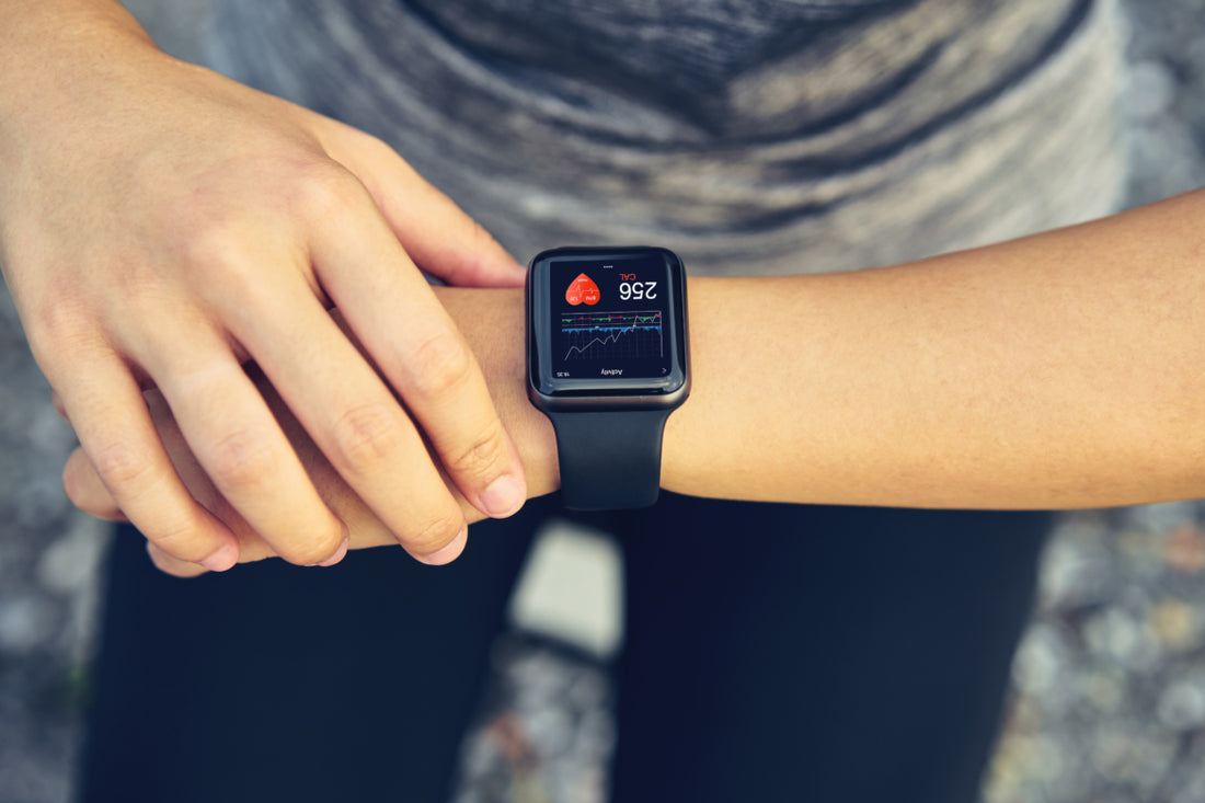 Person looking at their smart watch partway through a workout.