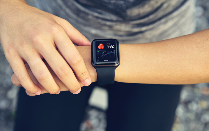 Person looking at their smart watch partway through a workout.