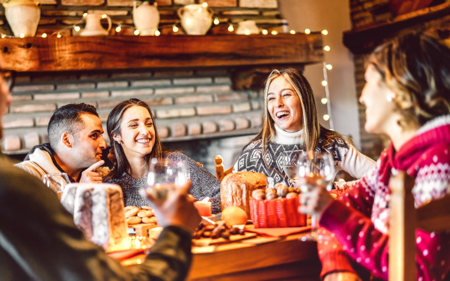 Group of young adults enjoying a holiday meal together. 