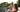 Couple drinking coffee and breathing while sitting on a terrace.