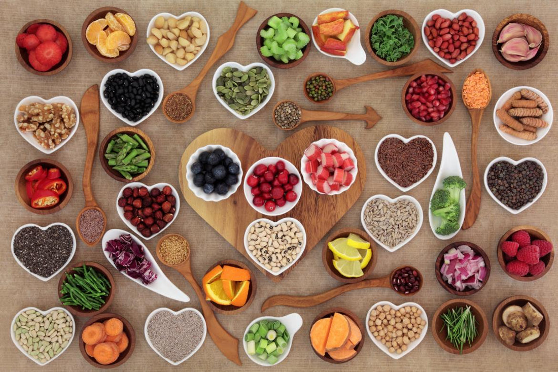 A top-down view of an array of superfoods in white dishes of various sizes spread out on a tabletop.