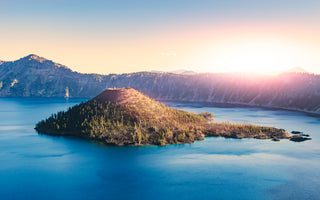 Crater Lake at sunset with Wizard Island in center view.