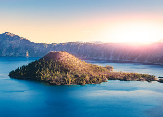 Crater Lake at sunset with Wizard Island in center view.