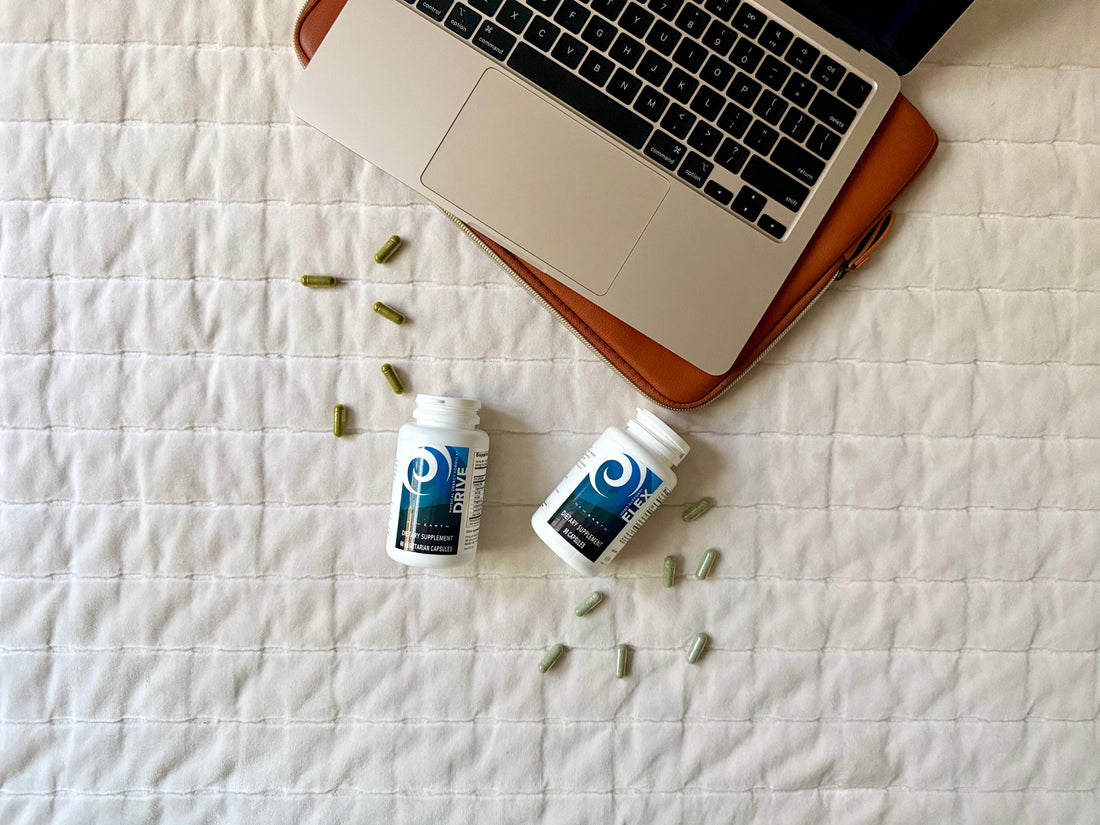 Bottles of Drive and Flex lying next to an open laptop.