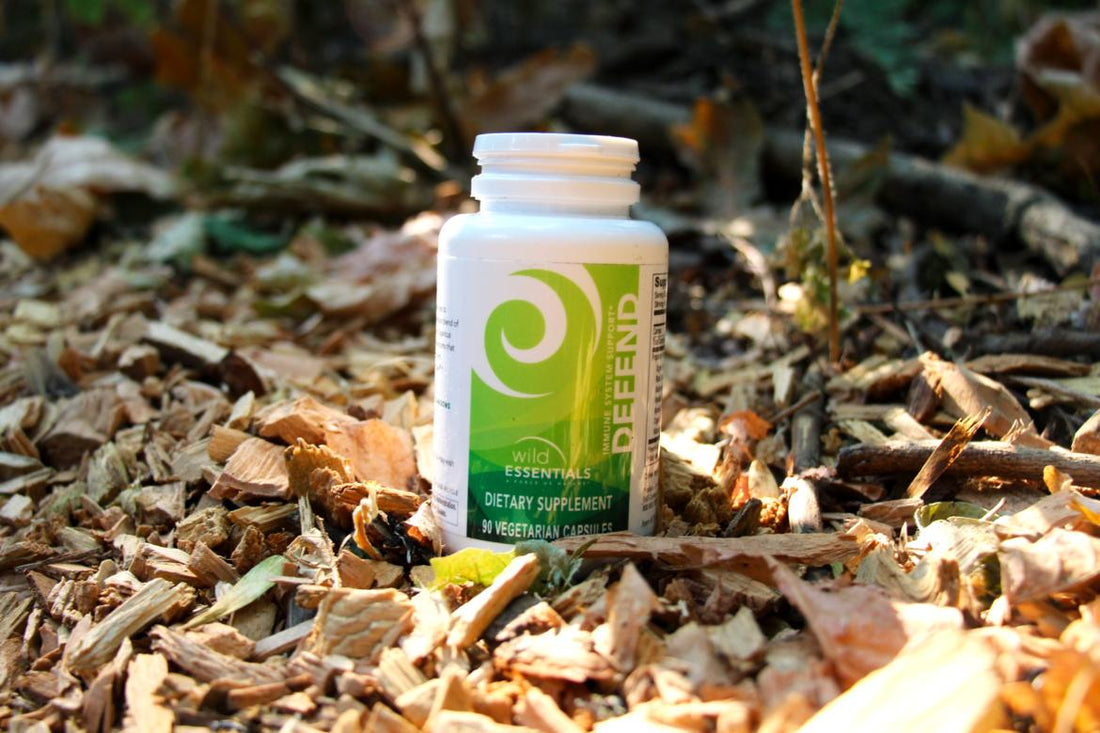 A bottle of New Earth's Defend sitting on the ground.