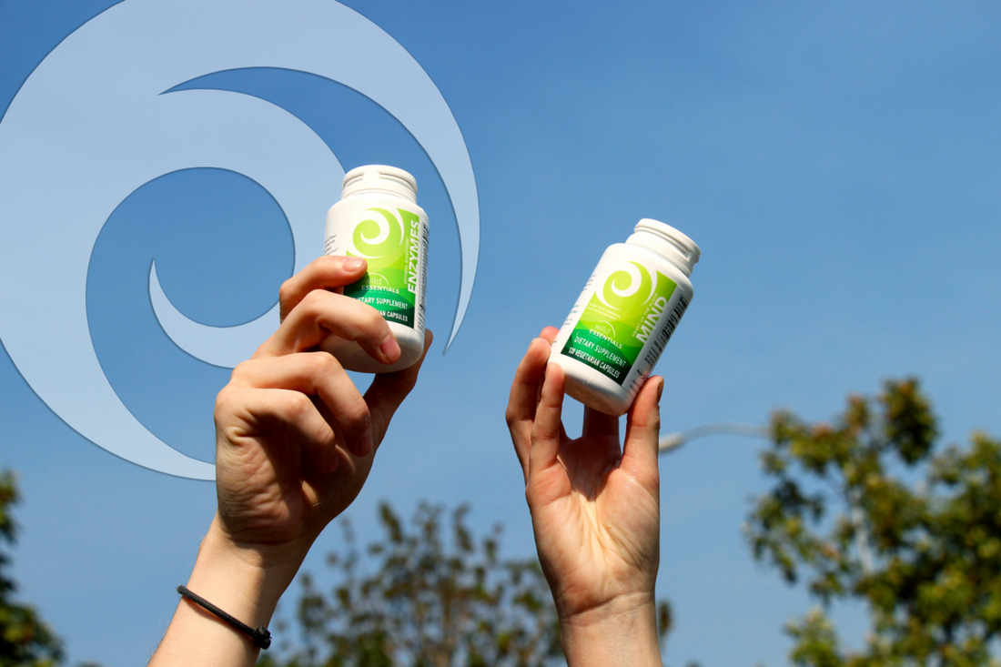 Two hands holding a bottle of New Earth's Enzymes and New Earth's Mind up in the air.